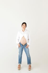 mother-to-be in neutral tones posing during timeless studio maternity session in Burbank