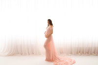 Expectant mother poses for Luxury, Editorial Style Studio Maternity Portraits at Holy City Babies Portrait Studio in Charleston, SC.