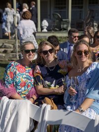 Guests smile at camera during wedding ceremony on Nantucket.