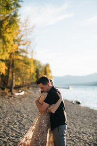 Couple embraces post adventure elopement on beach