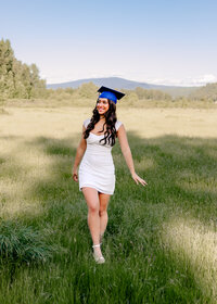 Sam Barlow High School senior getting her cap and gown portraits done in an open field in the Columbia River Gorge.