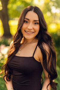 A Kettle Moraine High School senior stands in Waukesha's Frame Park surrounded by nature for a classic senior portrait.