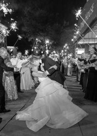 sparkler wedding exit downtown detroit as groom dips bride with a kiss