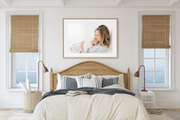 Large framed portrait of a mother and baby displayed above a bed as heirloom wall art
