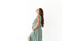 Expecting mother in a flowing dress during a serene maternity session in Bend, Oregon.