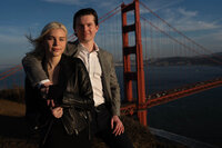 handsome couple embracing casually overlooking the golden gate bridge at sunset near battery spencer