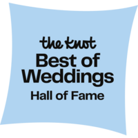 A square, light blue pillow with text "Iowa wedding planner the knot best of weddings hall of fame" in dark blue centered on the front.