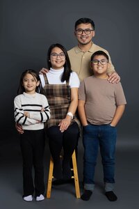 Parents holding children close during Edmonton family photography session