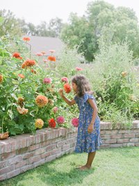 a girl smelling flowers