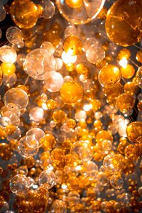 Bright orange baubles of different sizes fill the frame, set against a dark sky.