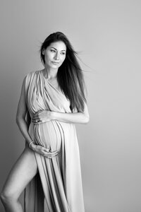 black and white maternity portrait of expecting mom during fine art studio session