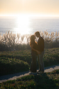 couple embracing in sunset sparkle ocean at seascape resort in aptos california
