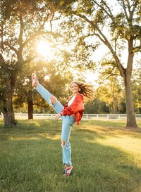 Senior portrait in downtown Magnolia Springs, Alabama — showing her kick moves from the high school dance team.