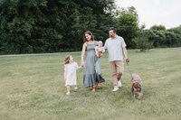 Family of 4 taking a stroll in Marie Curtis Park during family photos