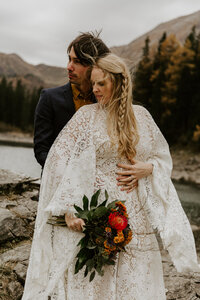 Bride and groom hugging austria alps