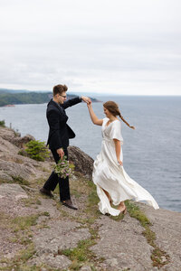 An eloping couple poses on the cliff