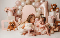 Charleston Cake Smash Photographer- Baby looks into the camera during Cake Smash Photos at Holy City Babies Portrait Studio in Charleston, SC.