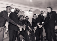 Candid black and white photo of Groom and Groomsmen toasting with whiskey in the grooms suite at The Troutdale House by the Sandy River