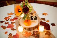Rustic autumn centerpiece with sunflowers and wood slice