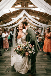 Natural wedding photography at Canonteign falls, capturing genuine Isle Kiss between couple