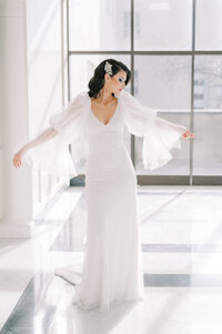 a bride shows off her gorgeous sleeves at The Leo Ballroom in Omaha