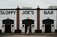 Couple in front of Le Meridien Tampa popping champagne after exchanging vows for their Tampa elopement