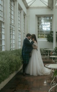 A beautiful and intimate moment of a married couple kissing and hugging each other, capturing their love and connection