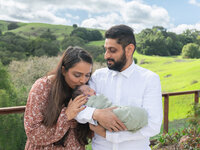 4Karma Studio - A cinematic family portrait with a newborn in the rolling hills of Los Angeles, featuring golden hour sunset lighting and an editorial lifestyle feel.