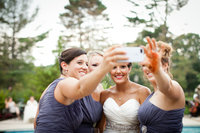 Bride photographed taking a selfie with her bridesmaids after the ceremony.