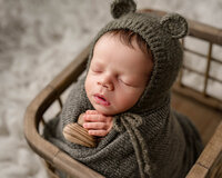 Sleeping newborn baby holding a wooden heart during a Baton Rouge newborn photography session