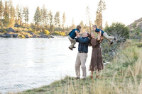 Candid family moment laughing together in a pine forest near Bend Oregon