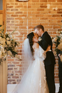 bride and groom first kiss at the ceremony