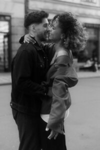 Candid photo of a laughing couple walking through Old Town Prague - authentic love story photography