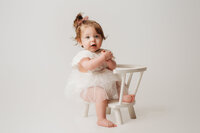 Charleston Cake Smash Photographer -- Baby celebrates her first birthday with a Cake Smash Photoshoot at Holy City Babies Portrait Studio in Charleston, SC.