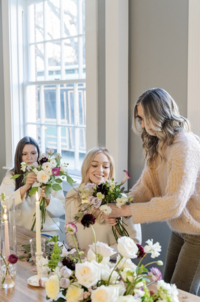 Three women designing bouquets at Maison Charlottesville. Photography by Jo Mahoney