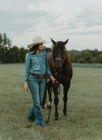 Senior portrait at Triple T Farms in Fruitdale, Alabama — standing beside her horse with legs
crossed.