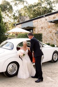 Bride arriving at a Golding Wines wedding in vintage car