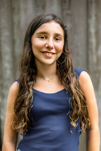 Close up portrait of teen girl with long brown hair during extended family photo session in Eastern North Carolina
