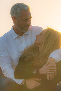 romantic couple embracing sunset engagement photos by the golden gate bridge at cavallo point