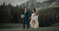 Couple walking the silvertip golf course at sunset on their wedding day.