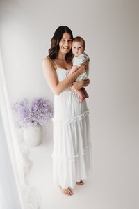 Charleston Mini Sessions - Mother embraces her baby during Mother's Day Mini Session at Holy City Babies in Charleston, SC.