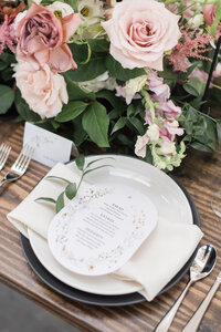 Reception place setting with menu card and soft florals in wedding photography Detroit MI