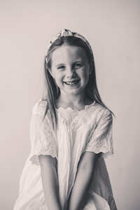 Young girl smiles at the camera during Personality Portrait Session in Charleston, SC.