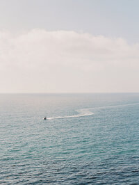 Kohnur ocean horizon view from a coastal cliffside showing vast blue water and a distant boat Amalfi Coast Salerno Italy