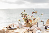 a decorated table top by the ocean