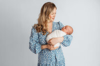 Newborn Pictures in Charleston - Mother embraces her newborn baby during Newborn Pictures at Holy City Babies Newborn Photography Studio in Charleston, SC.