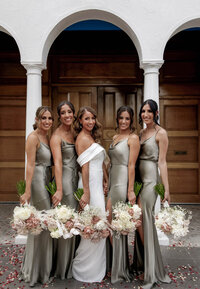 Bridesmaids standing together holding bouquets