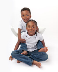 Brother and sister smiling together in studio portrait in Eastern North Carolina