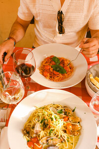 Lifestyle restaurant food photography featuring handmade pasta and wine service