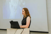 Jill Wright speaking at a conference about sustainable productivity, workload management, and high performance.